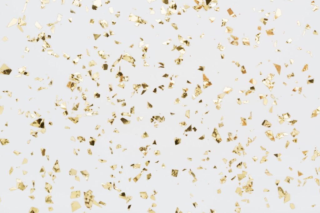 Golden Confetti on White Background.